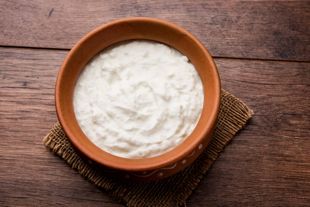 istock Plain curd or yogurt or Dahi in Hindi, served in a bowl over moody background. Selective focus 1049722128