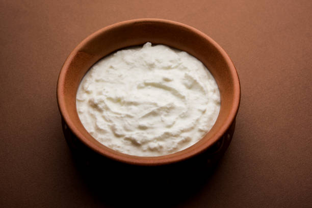istock Plain curd or yogurt or Dahi in Hindi, served in a bowl over moody background. Selective focus 1049722278