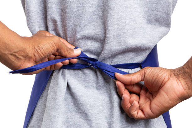 istock Hypermarket employee tying apron knot 1049722426