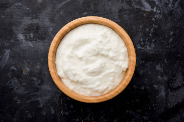 istock Plain curd or yogurt or Dahi in Hindi, served in a bowl over moody background. Selective focus 1049724618