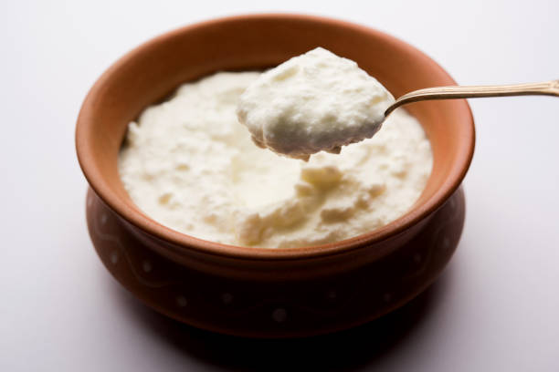 istock Plain curd or yogurt or Dahi in Hindi, served in a bowl over moody background. Selective focus 1049724698