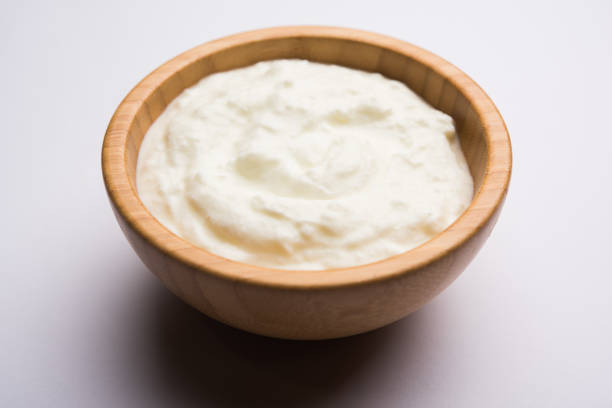 istock Plain curd or yogurt or Dahi in Hindi, served in a bowl over moody background. Selective focus 1049724872