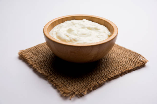 istock Plain curd or yogurt or Dahi in Hindi, served in a bowl over moody background. Selective focus 1049724928