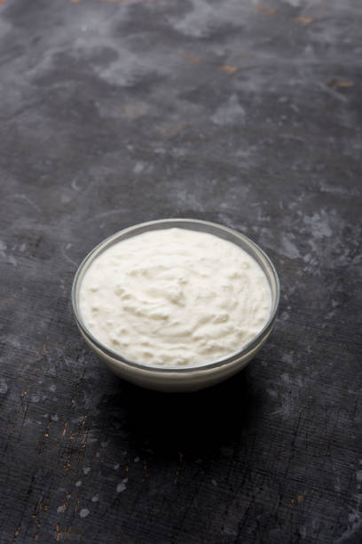 istock Plain curd or yogurt or Dahi in Hindi, served in a bowl over moody background. Selective focus 1049725260