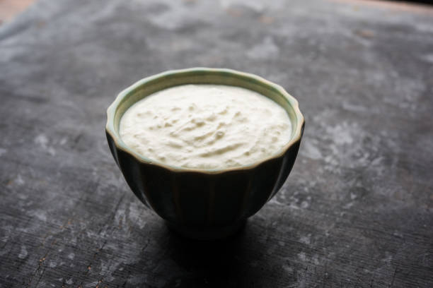 istock Plain curd or yogurt or Dahi in Hindi, served in a bowl over moody background. Selective focus 1049725376