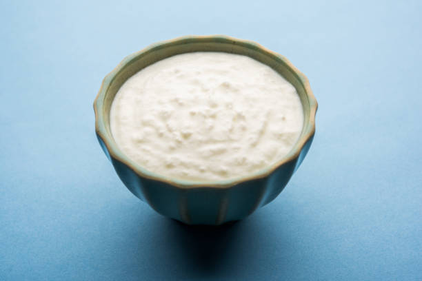 istock Plain curd or yogurt or Dahi in Hindi, served in a bowl over moody background. Selective focus 1049725604