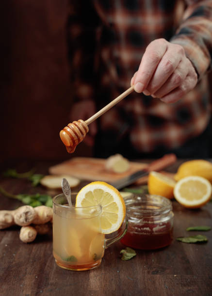 istock Ginger tea with honey , lemon and mint on old wooden table . 1049725766