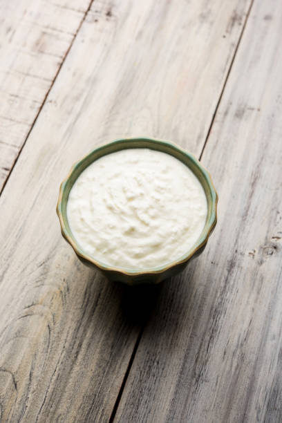 istock Plain curd or yogurt or Dahi in Hindi, served in a bowl over moody background. Selective focus 1049728108