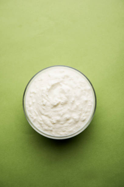 istock Plain curd or yogurt or Dahi in Hindi, served in a bowl over moody background. Selective focus 1049728256