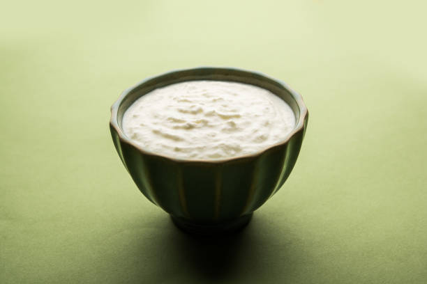istock Plain curd or yogurt or Dahi in Hindi, served in a bowl over moody background. Selective focus 1049728284
