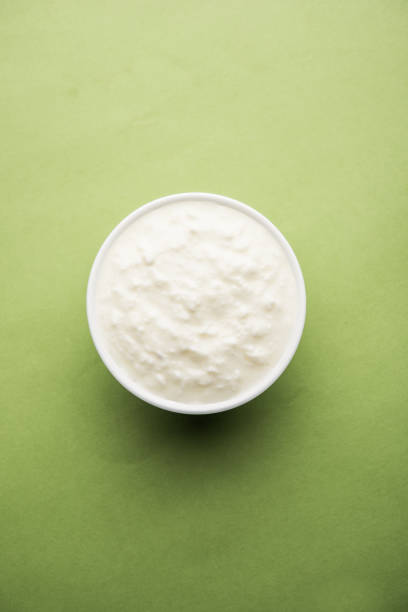 istock Plain curd or yogurt or Dahi in Hindi, served in a bowl over moody background. Selective focus 1049728388
