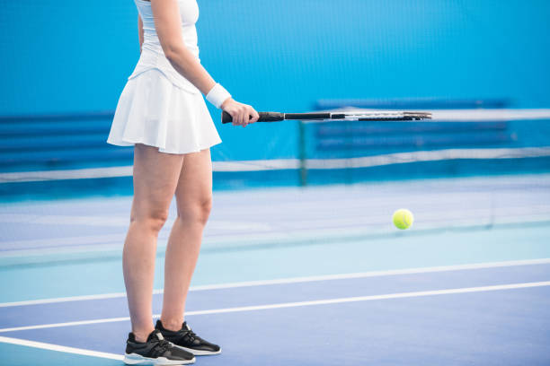 istock Woman Holding Tennis Racket 1049728400