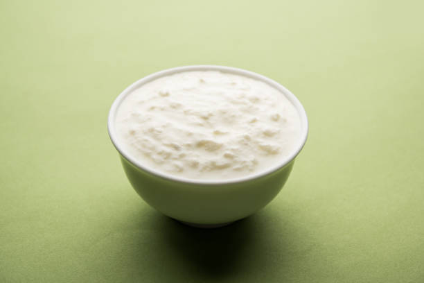 istock Plain curd or yogurt or Dahi in Hindi, served in a bowl over moody background. Selective focus 1049728468