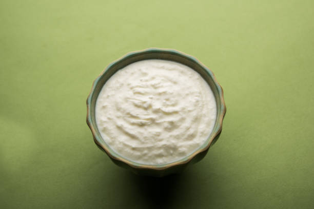 istock Plain curd or yogurt or Dahi in Hindi, served in a bowl over moody background. Selective focus 1049728618