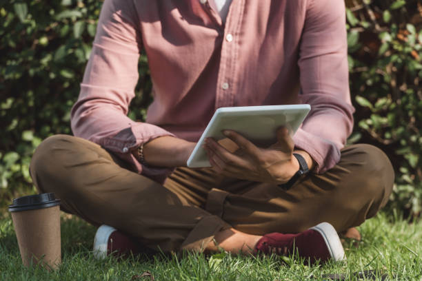 istock cropped shot of man using digital tablet in park 1049728656