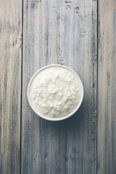 istock Plain curd or yogurt or Dahi in Hindi, served in a bowl over moody background. Selective focus 1049728702