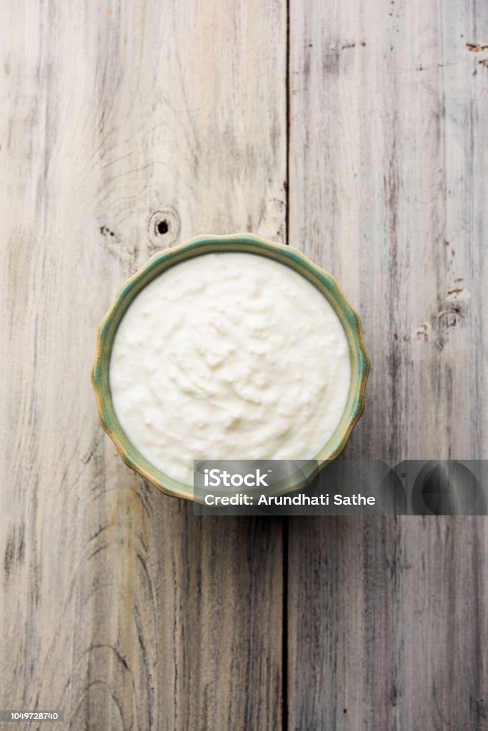 Plain curd or yogurt or Dahi in Hindi, served in a bowl over moody background. Selective focus Curd Cheese Stock Photo
