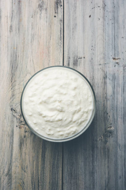 istock Plain curd or yogurt or Dahi in Hindi, served in a bowl over moody background. Selective focus 1049728880