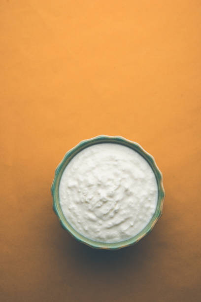 istock Plain curd or yogurt or Dahi in Hindi, served in a bowl over moody background. Selective focus 1049729126