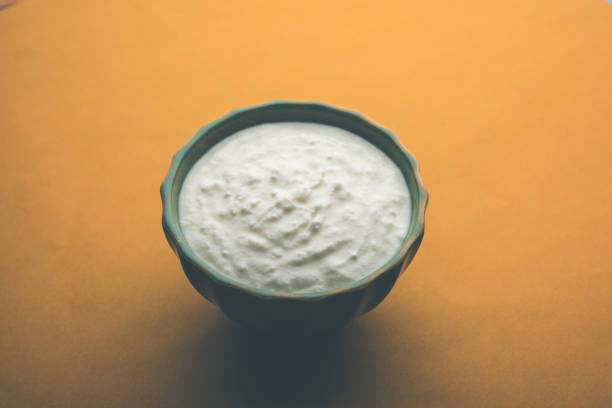 istock Plain curd or yogurt or Dahi in Hindi, served in a bowl over moody background. Selective focus 1049729150