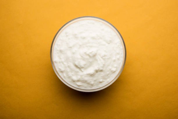istock Plain curd or yogurt or Dahi in Hindi, served in a bowl over moody background. Selective focus 1049729254