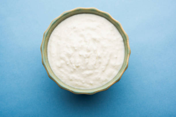 istock Plain curd or yogurt or Dahi in Hindi, served in a bowl over moody background. Selective focus 1049729390