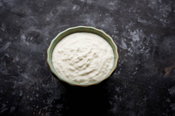 istock Plain curd or yogurt or Dahi in Hindi, served in a bowl over moody background. Selective focus 1049729814