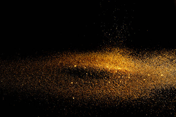 istock Sprinkle glitter gold dust sand in the dark 1049729816
