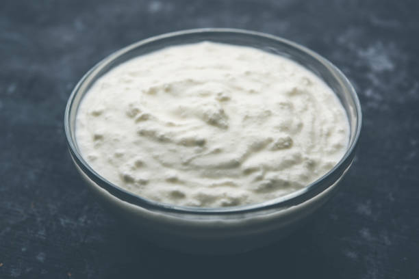 istock Plain curd or yogurt or Dahi in Hindi, served in a bowl over moody background. Selective focus 1049729886