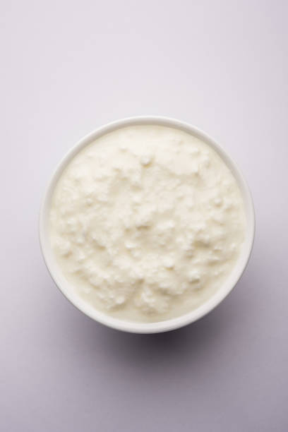 istock Plain curd or yogurt or Dahi in Hindi, served in a bowl over moody background. Selective focus 1049732012