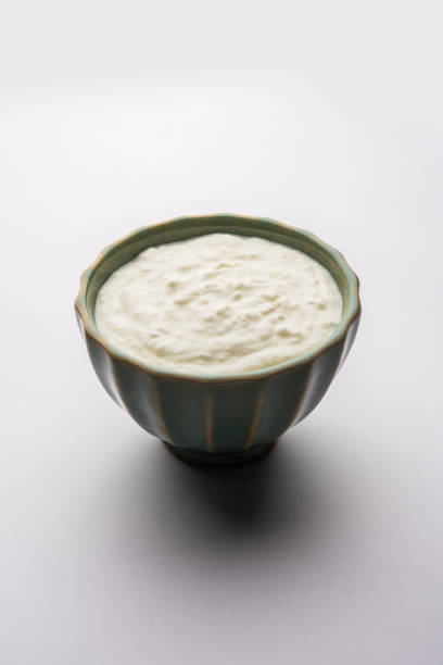 istock Plain curd or yogurt or Dahi in Hindi, served in a bowl over moody background. Selective focus 1049732020