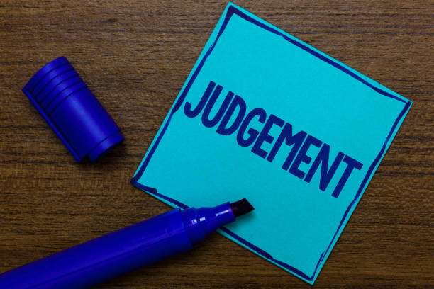 istock Writing note showing Judgement. Business photo showcasing ability make considered decisions come to sensible conclusions Blue Paper Important reminder Communicate ideas Wooden background. 1049732834