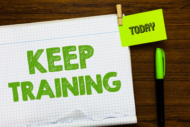 istock Writing note showing Keep Training. Business photo showcasing Grounding Drilling Always Wonder Be Curious Learn Open notebook page markers holding paper heart wooden background. 1049733228