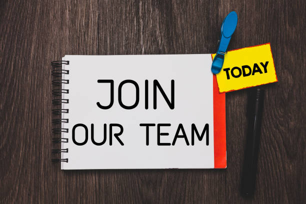 istock Writing note showing Join Our Team. Business photo showcasing Allied Associate Work with us New Employee Hired Enlist Open notebook white page clothespin holding reminder wooden background. 1049737112