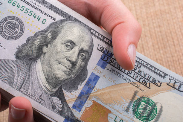istock Close up of Benjamin Franklin face on US dollar 1049739270