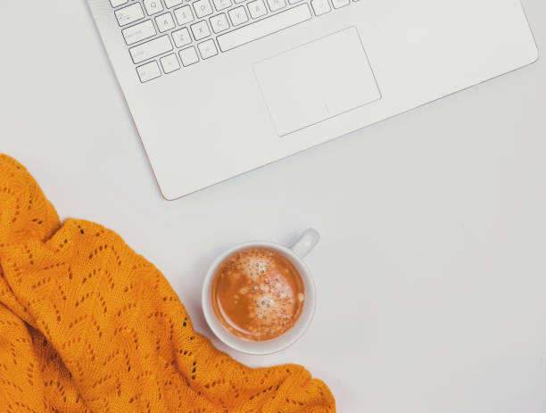 istock Computer, coffee and yellow sweater on the white background. 1049739460