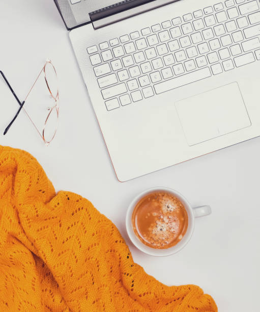istock Computer, coffee and yellow sweater on the white background. 1049739506