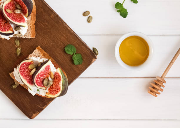 istock Delecious ricotta toast with figs and coffee on the white table 1049741924