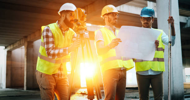 istock Team of construction engineers working on building site 1049742386