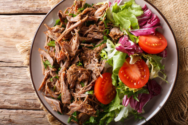 istock pulled spicy beef with fresh vegetables close-up on a table. horizontal top view from above 1049743948