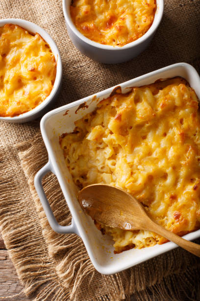 istock Delicious mac and cheese in a baking dish close-up on a table. Vertical top view 1049745716