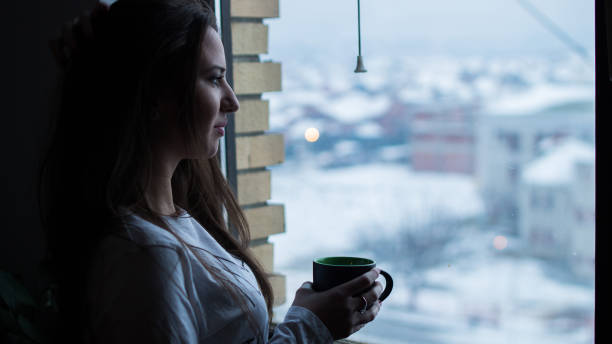 istock Drinking Coffee By The Window in Winter 1049747064