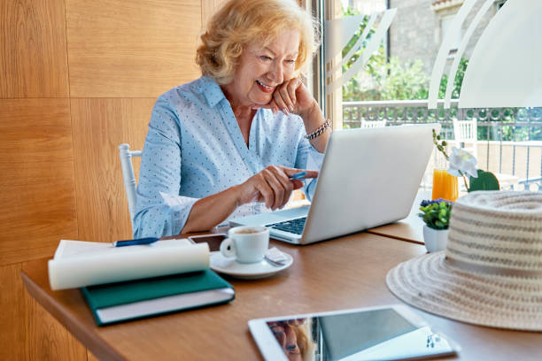 istock senior woman working on laptop 1049768726