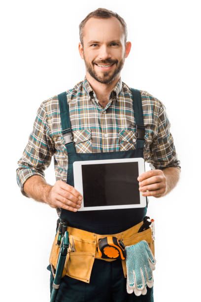 istock handsome smiling plumber showing tablet with blank screen isolated on white 1049769140