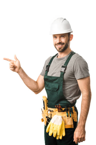 istock smiling handsome electrician pointing on something isolated on white 1049769274