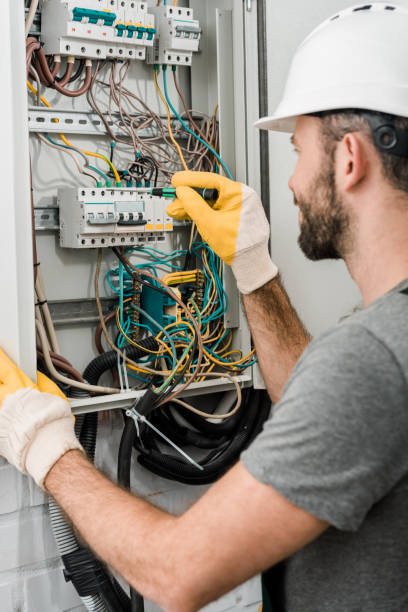 istock side view of electrician repairing electrical box and using screwdriver in corridor 1049769280