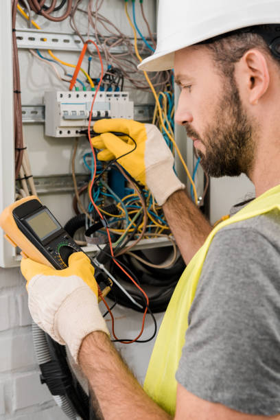 istock side view of bearded electrician checking electrical box with multimetr in corridor 1049769948