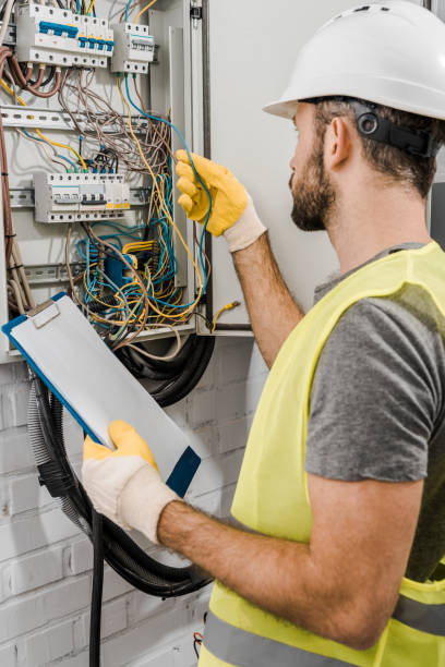 istock electrician holding clipboard and checking wires in electrical box in corridor 1049771380