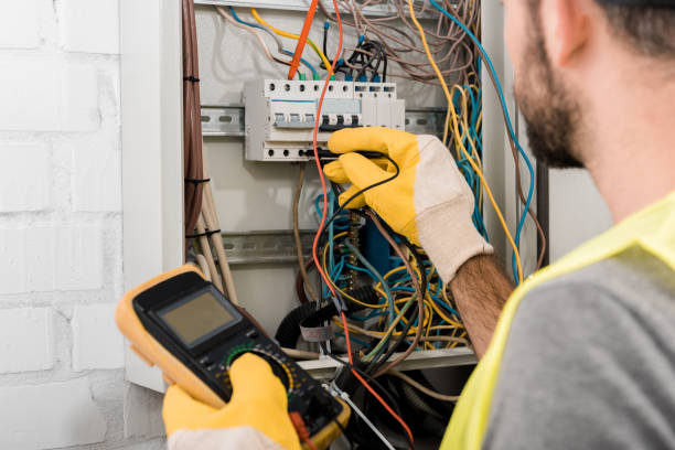 istock cropped image of electrician checking electrical box with multimetr in corridor 1049771418