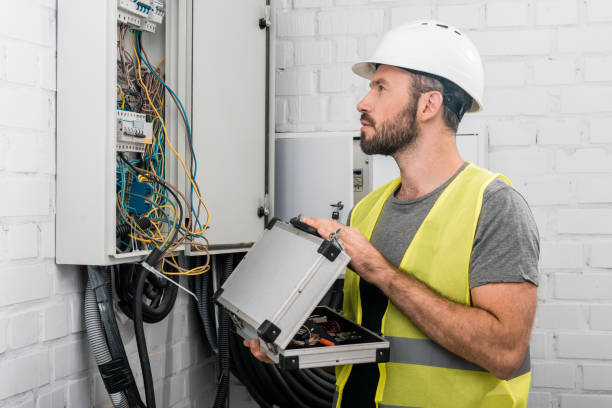 istock side view of handsome electrician holding toolbox and looking at electrical box in corridor 1049771424